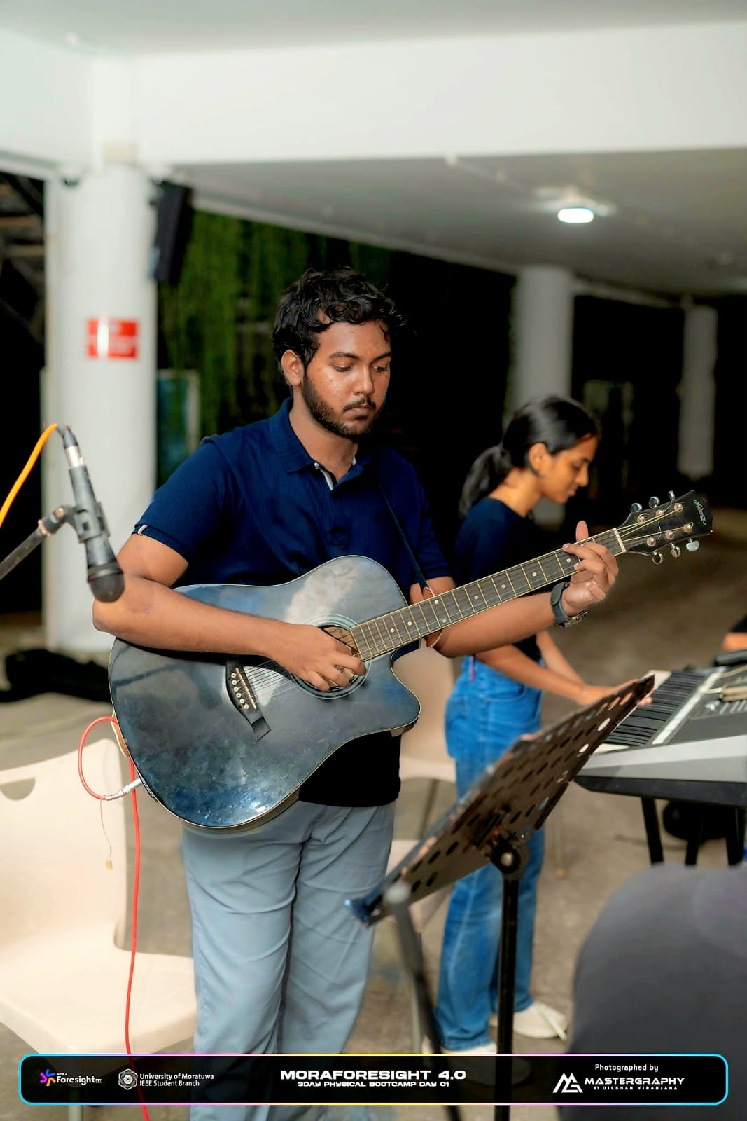 Performing with the guitar at Moraforesight 4.0 bootcamp