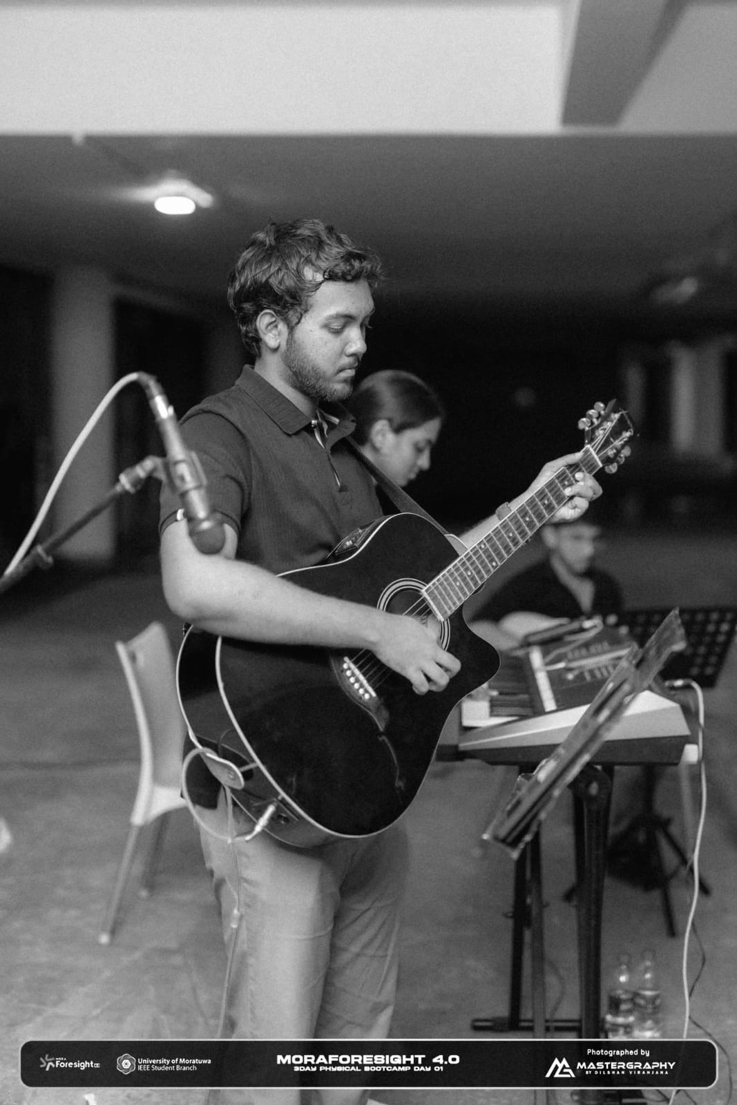 Black and white stage performance with the guitar